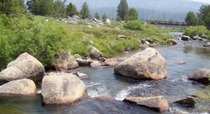 river with a bridge in the distance